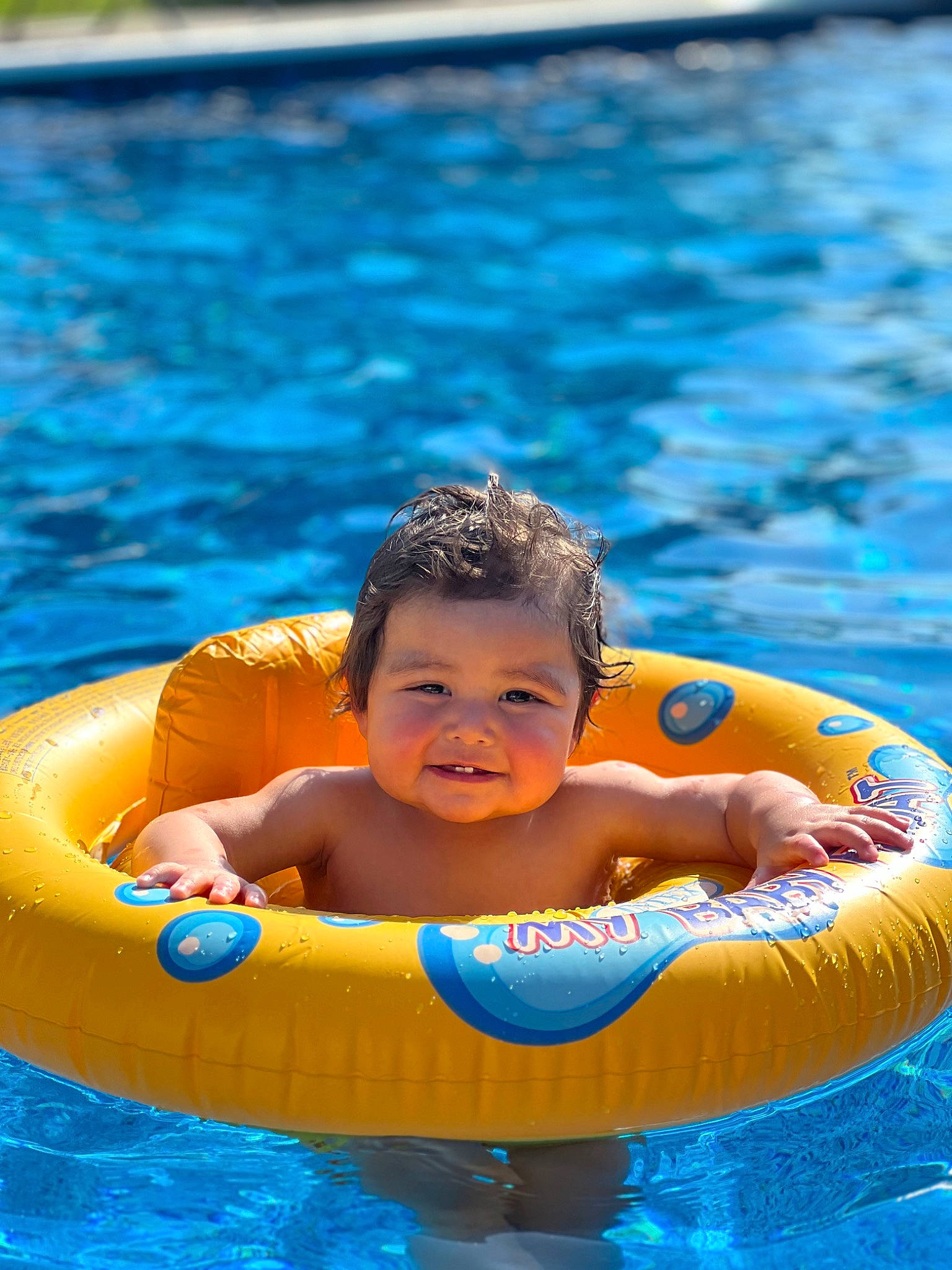 Emilio is registered to the contest to win money with this photo: aqua, azure, baby, baby_float, baby_products, bathing, blue, child, fun, games, happy, inflatable, leisure, outdoor_recreation, person, personal_protective_equipment, recreation, summer, swimming_pool, toddler