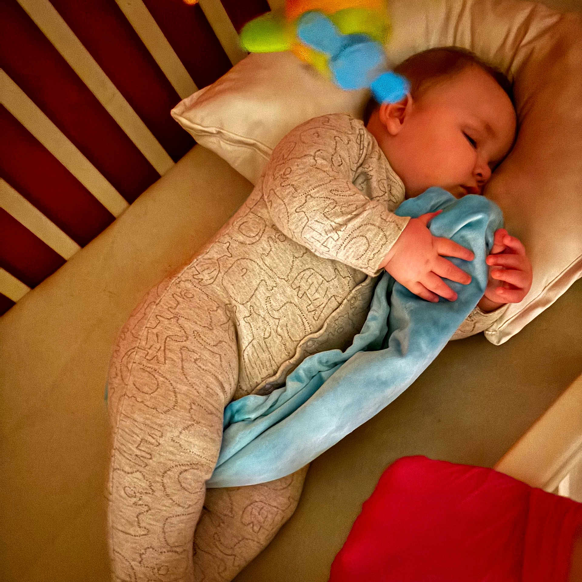 Noah is registered to the contest to win money with this photo: baby, blanket, crib, cushion, face, furniture, head, homedecor, infantbed, person, pillow, sleeping