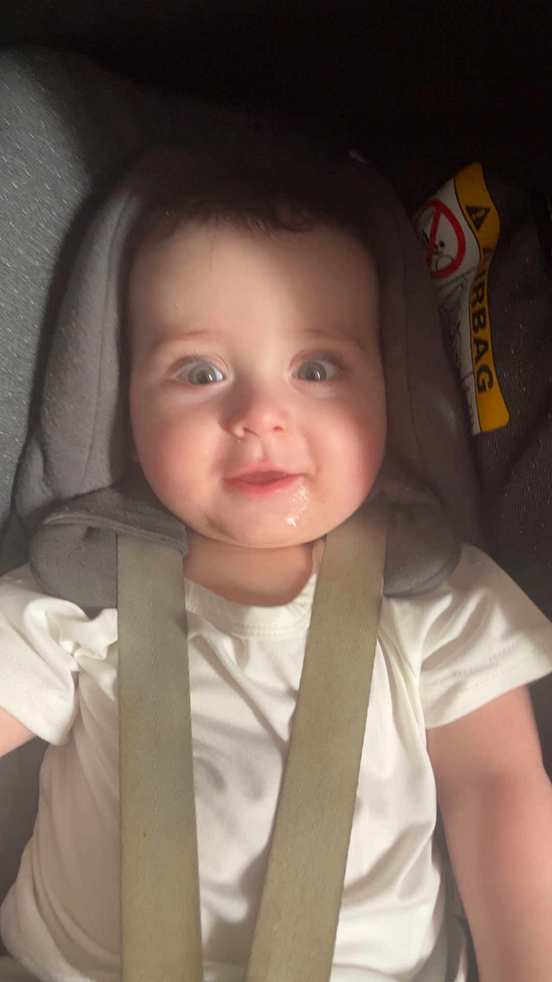 Eli joined the competition — help win amazing prizes! baby, child, car_seat, seatbelt, white_shirt, drool, happy, face, infant, straps, padded, safety, cute, closeup, portrait, indoors, headrest, smile, young, person