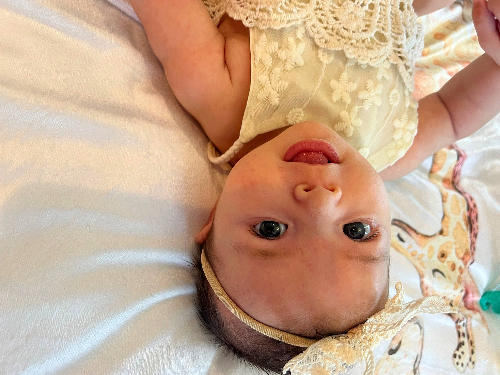 Isla is registered to the contest to win money with this photo: baby, baby_toddler_clothing, bridal_accessory, child, event, eye, eyelash, fashion_accessory, gesture, hair_accessory, happy, hat, headgear, headpiece, jewellery, pattern, peach, person, toddler, tradition