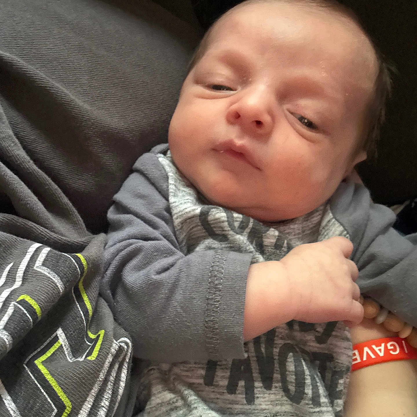 Daymian joined the competition — help win amazing prizes! baby, infant, child, clothing, hand, bracelet, sleepsuit, person, skin, face, expression, newborn, cute, indoors, portrait, babywear, resting, wrinkled_skin, casual, soft_lighting