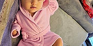 Isra participe au concours pour gagner de l'argent avec cette photo : baby, infant, child, pink_robe, hood, couch, sofa, blanket, indoor, foot, hand, face, eyes, expression, comfortable, soft_texture, home, relaxed, toddler, cute