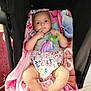 baby, infant, blanket, stroller, toy, headband, bow, floral, clothing, person, child, cute, legs, hand, face, indoor, carpet, pink, purple, green