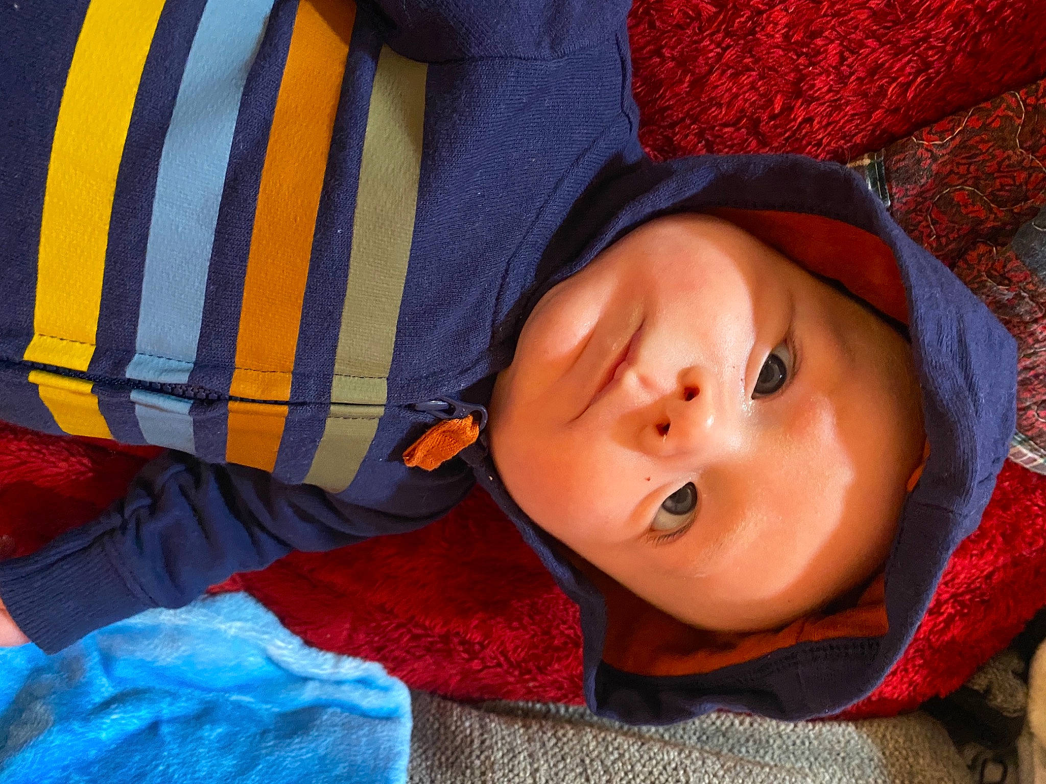 Atticus is registered to the contest to win money with this photo: blue, cap, cheek, child, chin, comfort, electric_blue, eyelash, headgear, headwear, knit_cap, lip, mouth, nose, orange, pattern, person, red, sleeve, textile