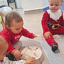 Nina participe au concours pour gagner de l'argent avec cette photo : child, toddler, indoor, playtime, sand, floor, red_clothing, santa_costume, toy, hands, messy, young_children, casual, curly_hair, short_hair, concentration, group, candid, light, home