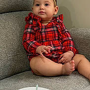 Gianna is registered to the contest to win money with this photo: baby, child, girl, plaid_dress, headband, bow, couch, gray_couch, plate, dessert, candle, raspberries, food, sitting, indoor, cute, portrait, celebration, holiday, happy