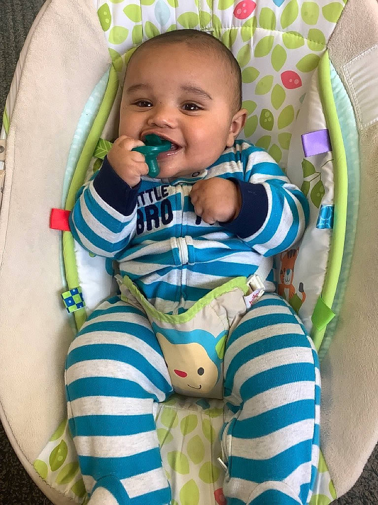 Brody is registered to the contest to win money with this photo: baby, baby_products, baby_safety, baby_toddler_clothing, chair, cheek, child, circle, comfort, fun, happy, linens, pattern, person, sitting, sleeve, smile, toddler