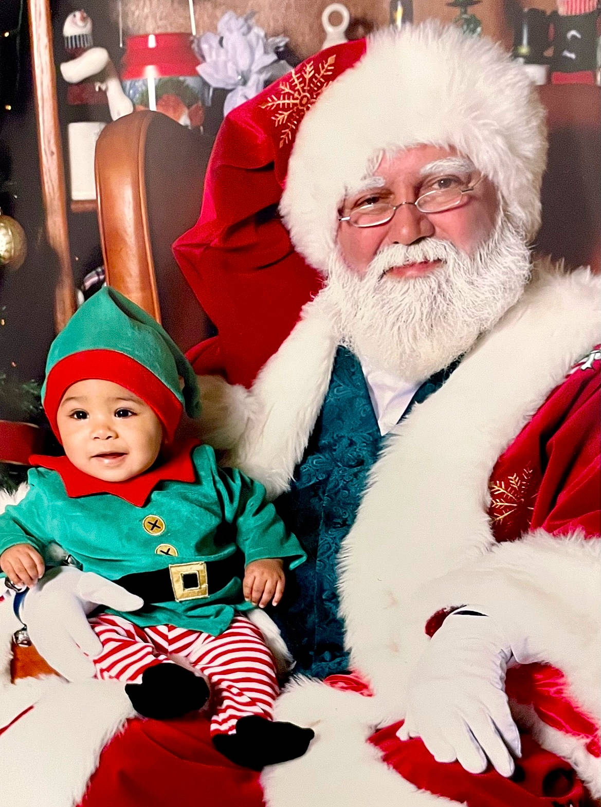Josiah is registered to the contest to win money with this photo: baby, beard, christmas, christmas_eve, costume_hat, event, facial_expression, facial_hair, fictional_character, fun, happy, hat, head, headwear, holiday, human_body, lap, person, red, santa_claus