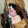 Jaylianette is registered to the contest to win money with this photo: baby, baby_carriage, blanket, canopy, child, closed_eyes, cozy, fabric, fashionable, floor, headwrap, indoor, infant, peaceful, pink_outfit, portrait, seated, sleeping, stroller, tan_stroller