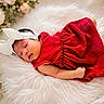 baby, bed, close_up, cozy, cute, fashion, floral, flowers, fluffy_blanket, headband, indoor, infant, newborn, peaceful, photography, portrait, red_dress, resting, sleeping, white_bow