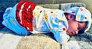 Jaylianette joined the competition — help win amazing prizes! baby, blanket, closed_eyes, clothing, colorful, couch, cozy, face, hat, indoors, infant, lying_down, newborn, onesie, peaceful, portrait, resting, sleeping, soft_blanket, textile