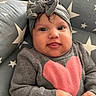 adorable, baby, bow, child, close_up, cozy, cushion, eyes, face, gray_headband, hands, heart, indoor, infant, photography, portrait, seated, smiling, stars, sweater