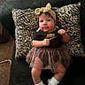 baby, bow, child, couch, headband, home, indoors, infant, leopard_print, nike, pillow, portrait, ruffles, shirt, sitting, skirt, smiling, socks, sofa, tutu