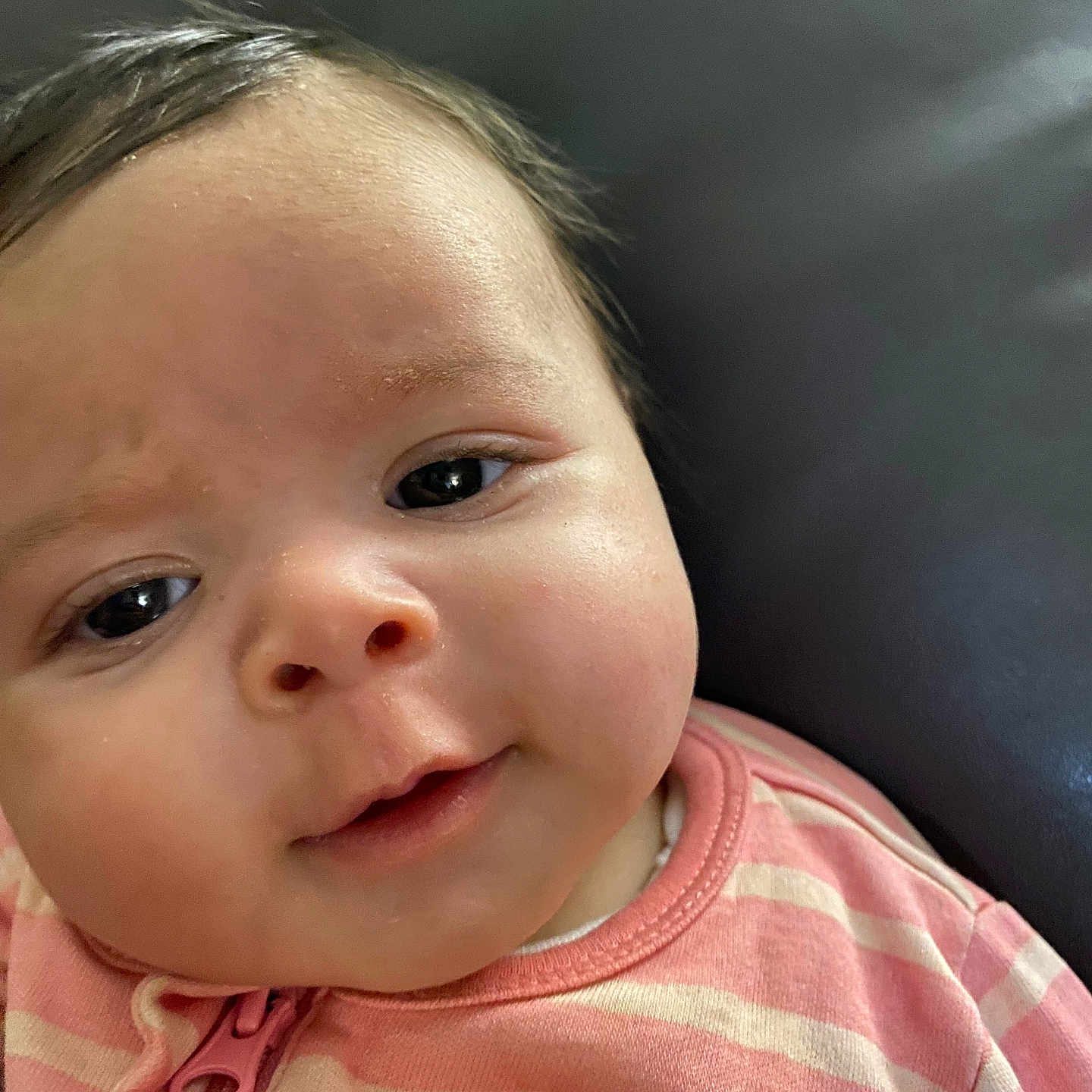 Katana is registered to the contest to win money with this photo: baby, background, child, closeup, cute, expression, eyes, face, head, indoor, infant, mouth, nose, person, pink_clothing, portrait, skin, soft_light, striped_clothing, young