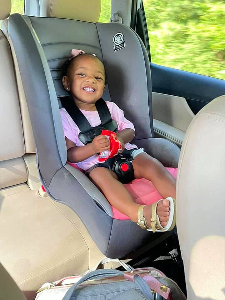 Allyson is registered to the contest to win money with this photo: auto_part, automotive_design, automotive_exterior, car, car_seat, car_seat_cover, comfort, family_car, head_restraint, joy, luxury_vehicle, motor_vehicle, person, plant, seat_belt, smile, steering_part, steering_wheel, toddler, vehicle