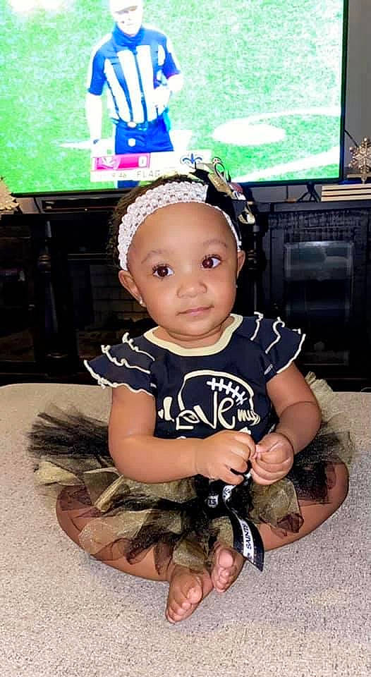 Allyson is registered to the contest to win money with this photo: audio_equipment, baby, baby_toddler_clothing, camouflage, child, fashion_accessory, flash_photography, gadget, happy, human_leg, leg, military_camouflage, pattern, person, personal_protective_equipment, sleeve, smile, t_shirt, television, thigh