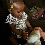 Samariah is registered to the contest to win money with this photo: accessories, baby, bag, bodypart, child, couch, diaper, face, female, finger, furniture, girl, hand, handbag, happy, head, person, photography, portrait, purse