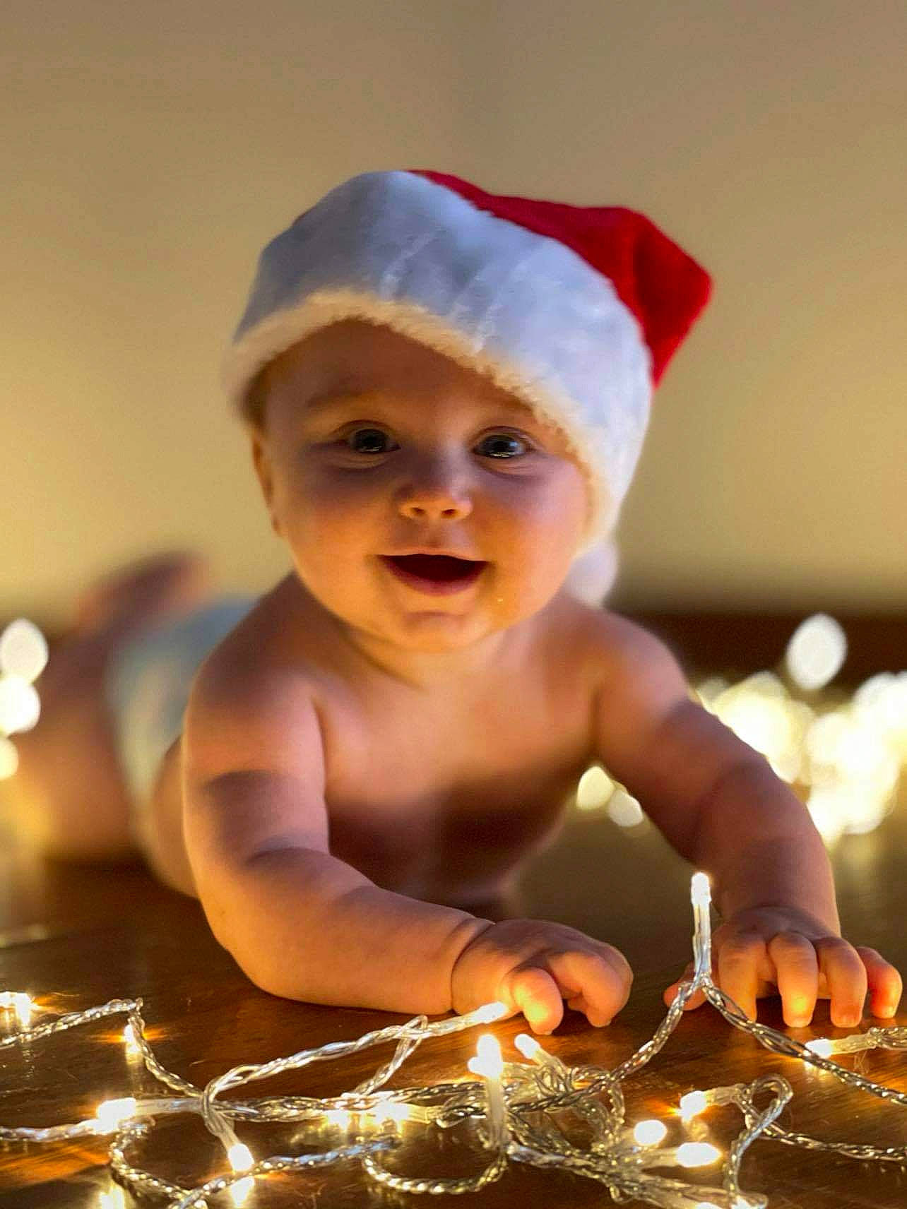 Tanner is registered to the contest to win money with this photo: baby, barechested, bonnet, child, christmas, costume_accessory, costume_hat, fictional_character, finger, headgear, headwear, holiday, muscle, person, toddler