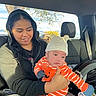Saione Ho Ching is registered to the contest to win money with this photo: baby, child, infant, car, vehicle, sitting, holding, portrait, face, smiling, hat, striped_clothing, orange_outfit, pumpkin_costume, bear_ears, indoor, autumn, sunlight, family, travel