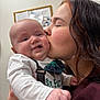 Malachi is registered to the contest to win money with this photo: baby, infant, woman, kiss, affection, portrait, close_up, indoor, smile, cheek, nose_ring, bow_tie, onesie, holding, family, love, candid, clothing, happy, skin