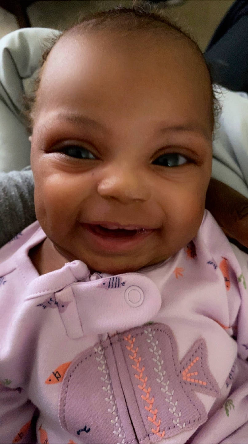 Marley is registered to the contest to win money with this photo: baby, cheek, chin, ear, eye, eyebrow, eyelash, facial_expression, forehead, gesture, happy, human, iris, joy, lip, mouth, nose, person, skin, sleeve