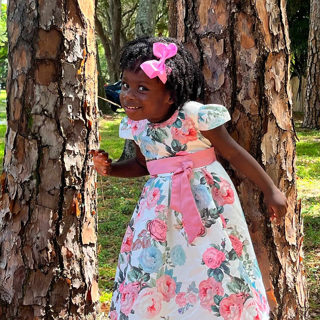 Jewelameda is registered to the contest to win money with this photo: child, clothing, dress, face, female, girl, grass, grove, head, land, nature, outdoors, person, photography, plant, portrait, tree, treetrunk, vegetation, woodland