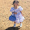 Arabella joined the competition — help win amazing prizes! toddler, child, dress, blue_handbag, smile, outdoor, gravel, sunlight, shoes, happy, person, cute, fashion, summer, young, playful, hair, standing, accessory, daylight