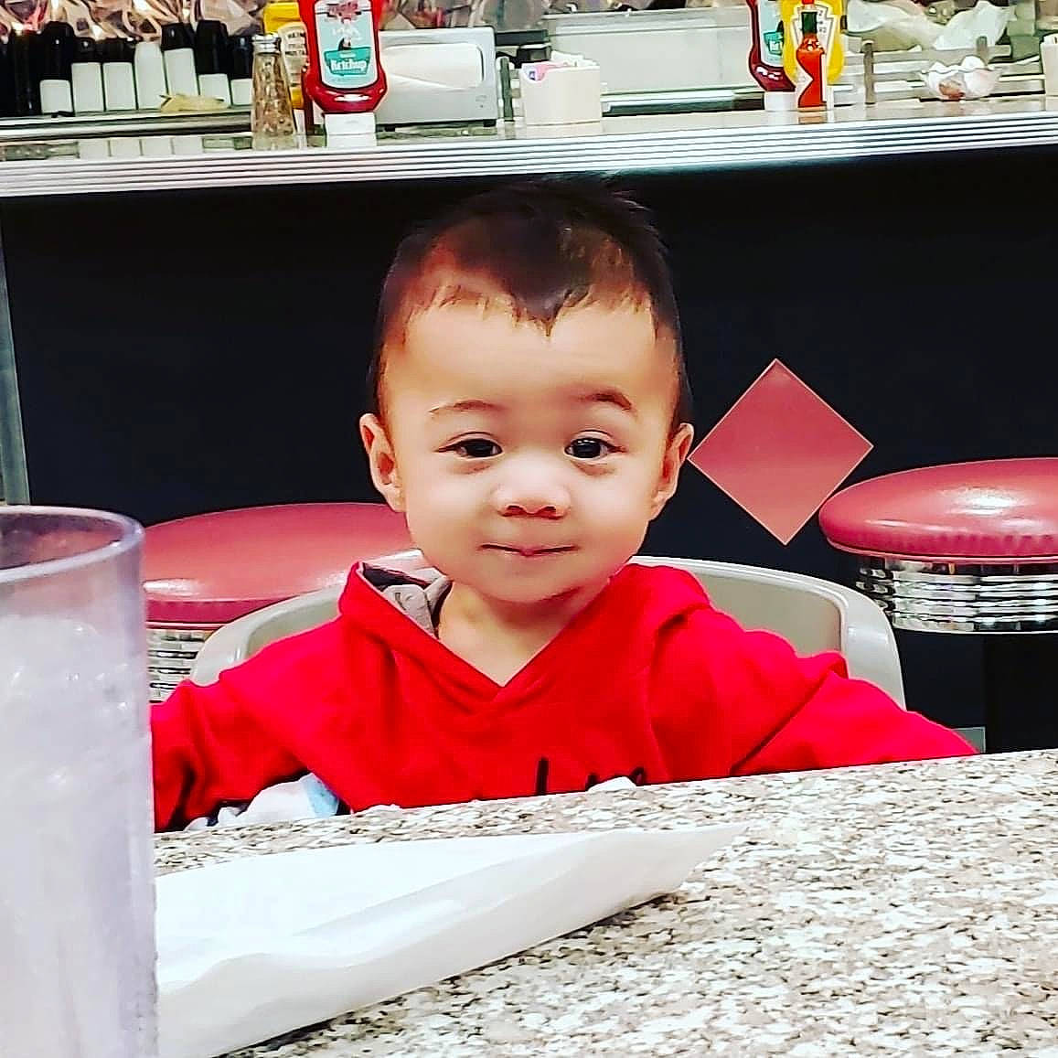 Kaiser is registered to the contest to win money with this photo: baby, carmine, child, drink, drinkware, fun, happy, leisure, person, play, room, sitting, smile, t_shirt, toddler, travel, vacation