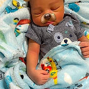 Zaiden Baxter joined the competition — help win amazing prizes! baby, infant, sleeping, portrait, dog_filter, digital_effect, blanket, striped_shirt, onesie, bed, indoors, cozy, cute, closed_eyes, face, hands, textile, colorful, resting, child