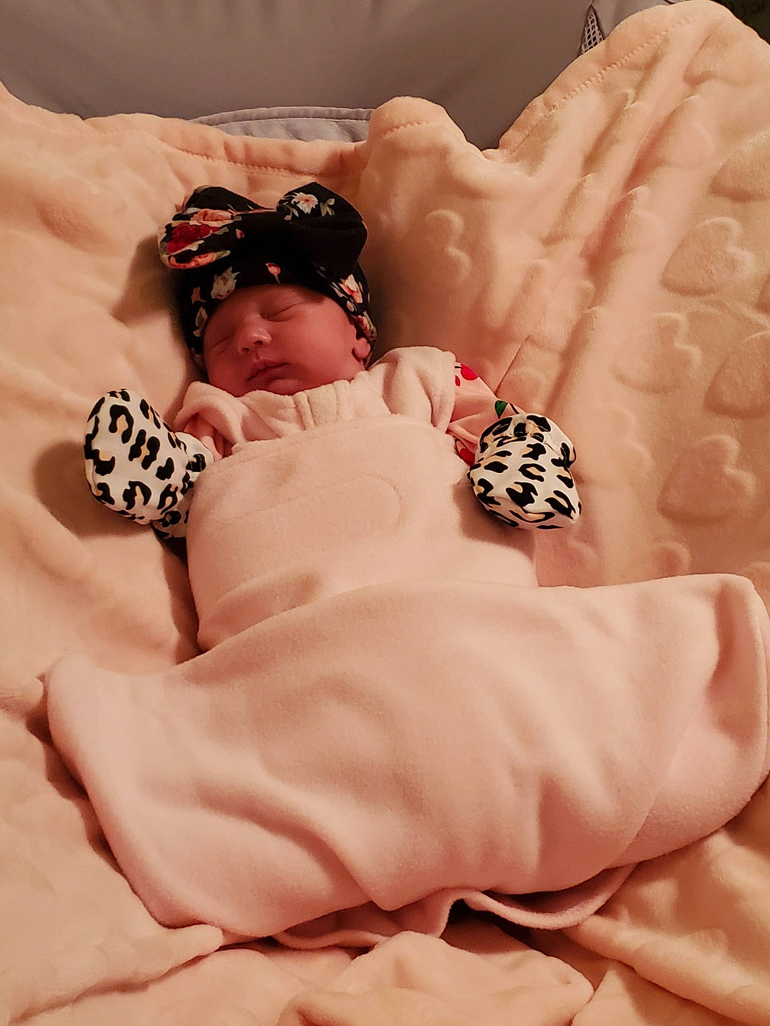 Letty is registered to the contest to win money with this photo: baby, bed_sheet, child, hair_accessory, headpiece, headwear, linens, person, pink, textile