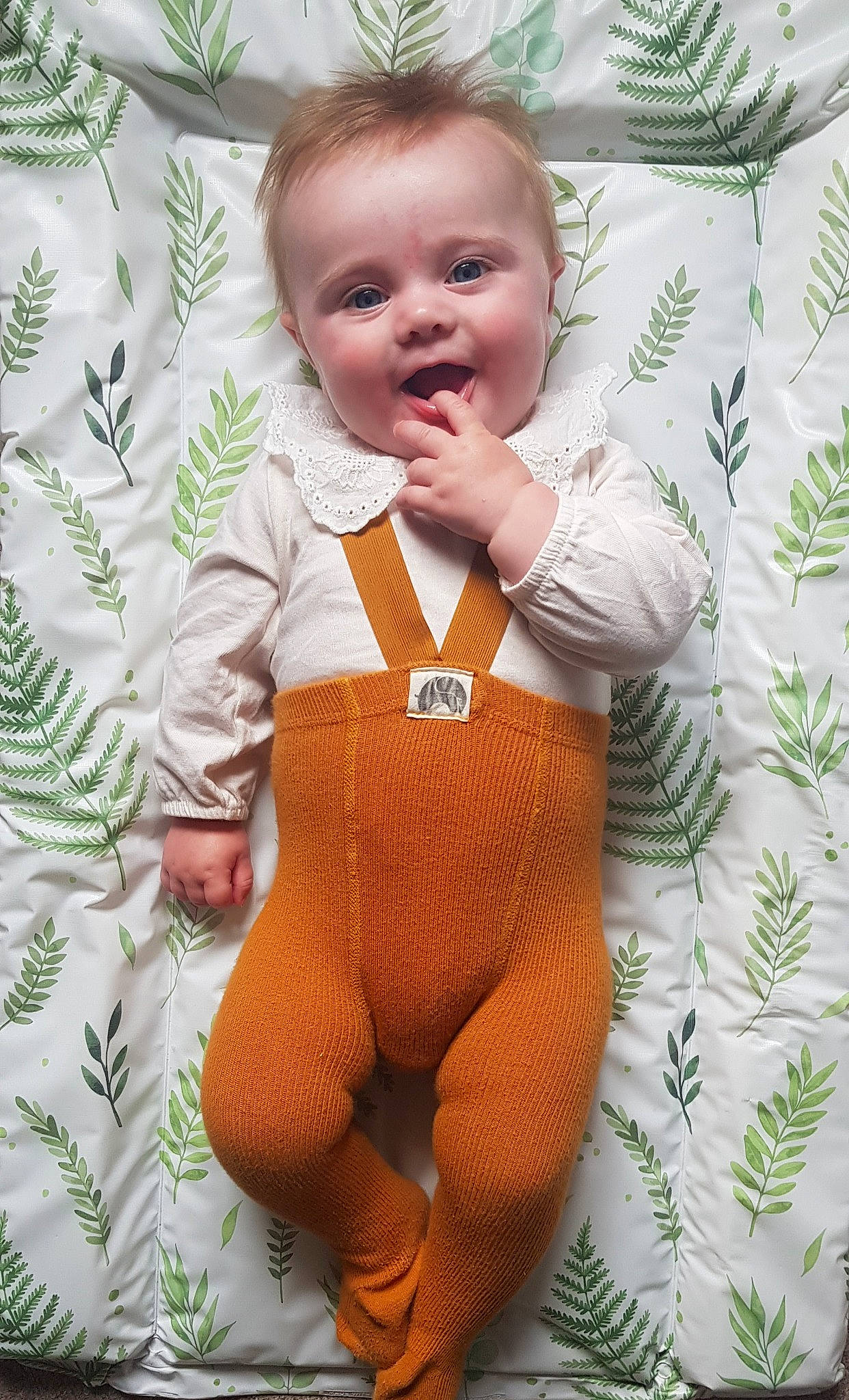 Maeve is registered to the contest to win money with this photo: abdomen, arm, baby, baby_toddler_clothing, chest, eye, face, finger, happy, head, linens, neck, pattern, person, sleeve, smile, stomach, t_shirt, textile, toddler