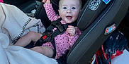 Olive joined the competition — help win amazing prizes! baby, car_seat, car_interior, smiling, child, pink_clothing, blanket, safety_harness, seat, window, door, seatbelt, happy, infant, rear_facing, vehicle, child_safety, graco, polka_dot, person