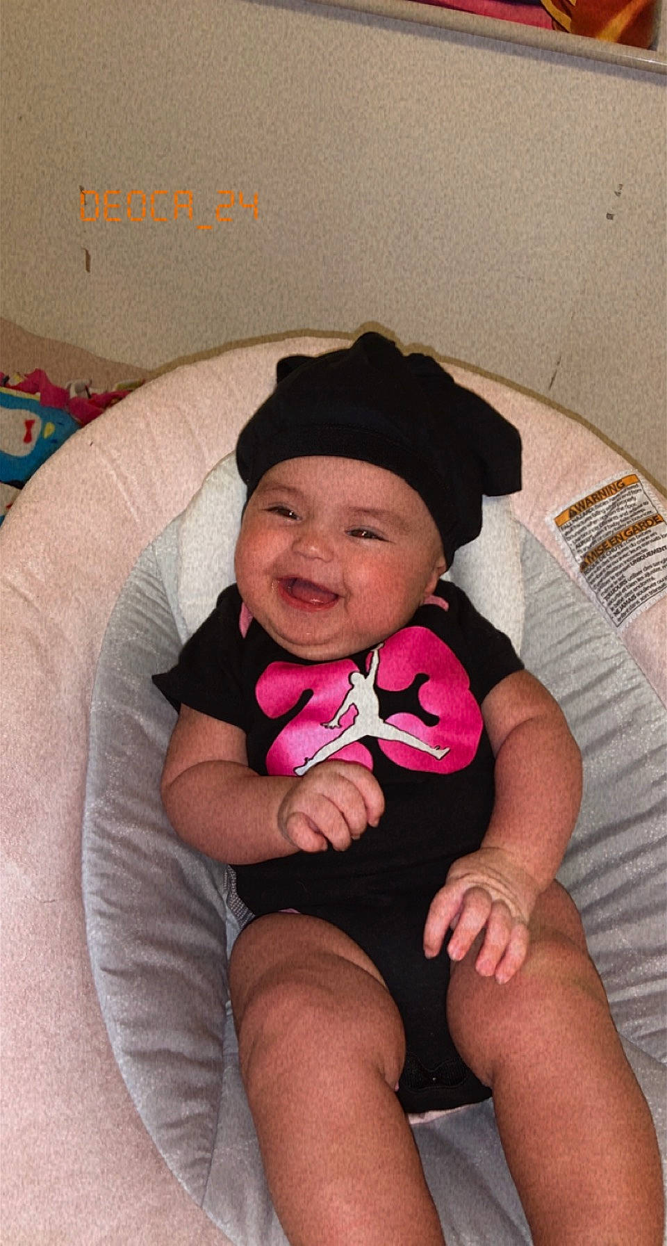 Anahi is registered to the contest to win money with this photo: baby, baby_toddler_clothing, comfort, eye, finger, happy, hat, head, headgear, headwear, joy, knee, lap, leg, lip, mouth, person, pink, skin, smile