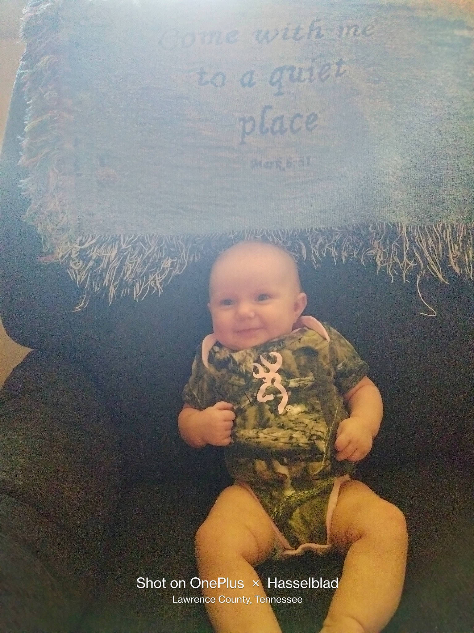 Sherry is registered to the contest to win money with this photo: baby, blackboard, blurred, chalk, child, comfort, flooring, font, fun, handwriting, happy, human_leg, knee, lap, person, plant, room, sitting, t_shirt, thigh