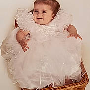 Lelia joined the competition — help win amazing prizes! baby, child, white_dress, frills, wicker_basket, smiling, portrait, cute, happy, pigtails, infant, sitting, indoors, adorable, young_child, fashion, person, celebration, cute_hair, baby_girl