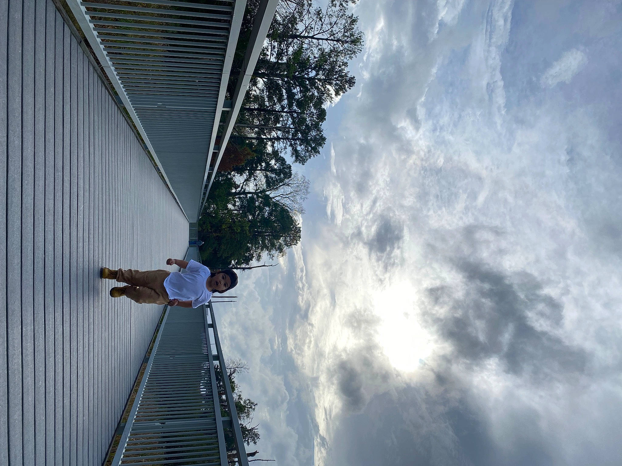 Levi is registered to the contest to win money with this photo: building, cloud, cumulus, daylighting, electric_blue, facade, handrail, headwear, leisure, person, plant, recreation, reflection, sky, stairs, tree, water, world