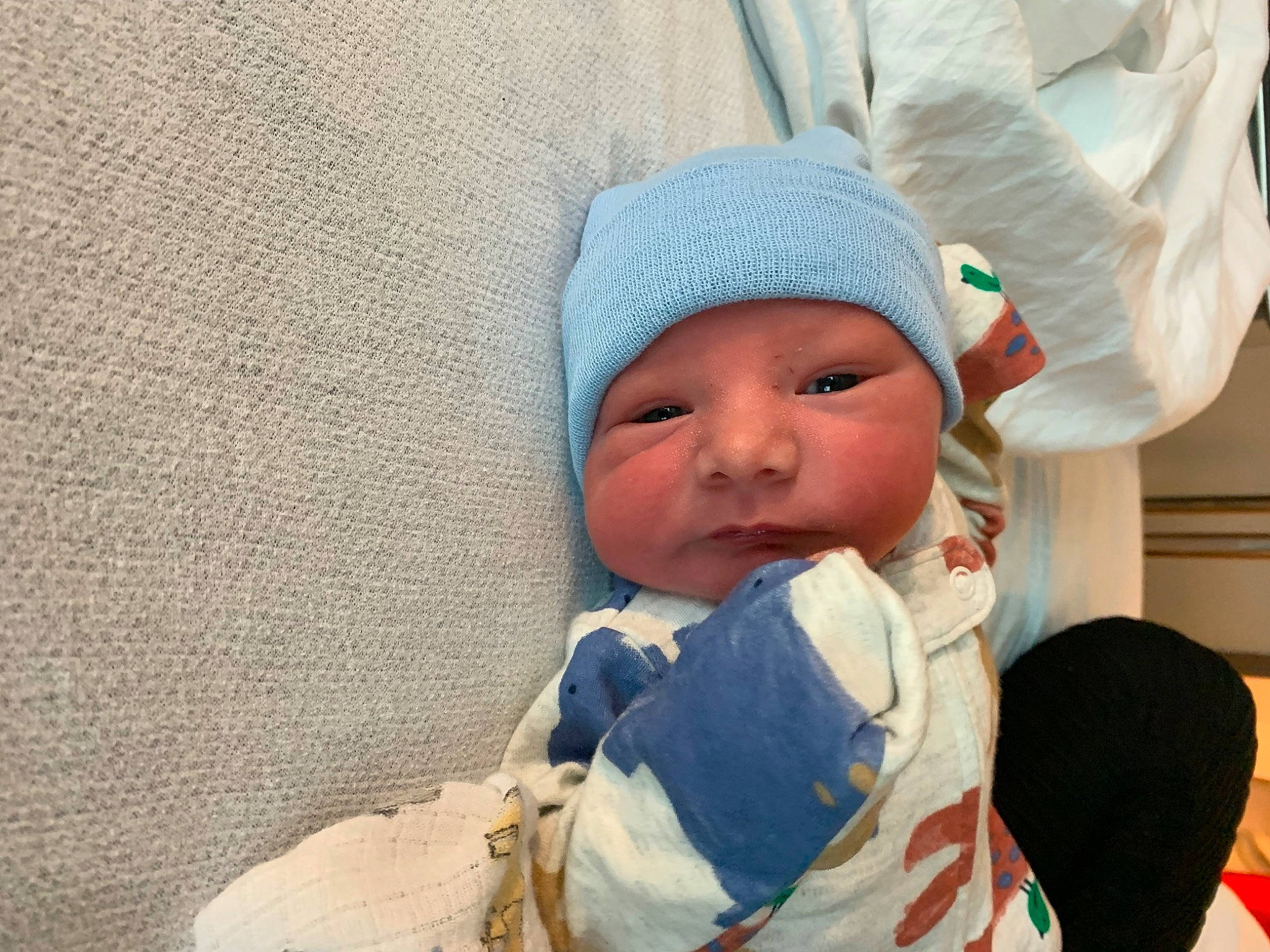 Jonah is registered to the contest to win money with this photo: baby, baby_products, baby_safety, baby_sleeping, baby_toddler_clothing, cap, cheek, child, comfort, face, gesture, happy, headgear, headwear, linens, nose, person, skin, sleeve, toddler