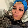 animal, cat, closeup, cozy, cute, eyelashes, freckles, fur, head_wrap, indoor, nose_ring, person, pet, pillow, portrait, relaxing, resting, sleeping_cat, snuggling, tabby_cat