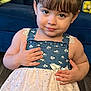 child, girl, portrait, indoor, dress, blue, white, flower_pattern, sparkle, braided_hair, bangs, smile, hands, couch, floor, person, young, cute, fashion, happy