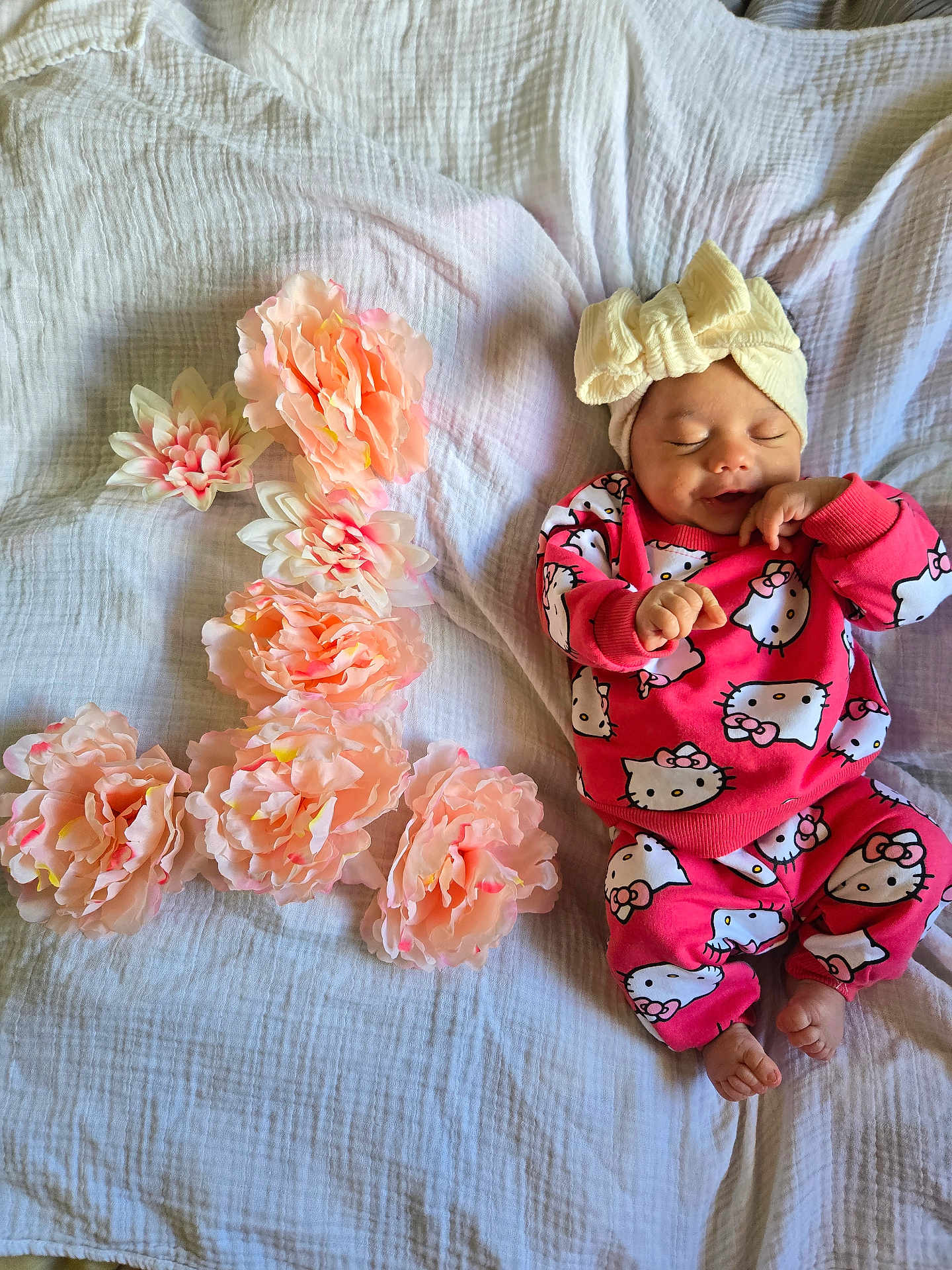 Gireh joined the competition — help win amazing prizes! baby, infant, sleeping, smiling, headband, bow, hello_kitty, pink_clothing, flowers, peach_flowers, blanket, soft_texture, cute, child, portrait, resting, indoors, cozy, happy, newborn