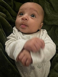 Kai is registered to the contest to win money with this photo: baby, baby_toddler_clothing, cheek, child, collar, comfort, eye, eyebrow, flash_photography, gesture, happy, head, iris, lip, nose, person, sitting, skin, sleeve, smile