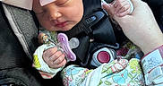 Kinlee is registered to the contest to win money with this photo: newborn, baby, sleeping, car_seat, infant, bow, headband, pacifier, harness, seatbelt, floral_outfit, blanket, hand, wristband, vehicle, portrait, closeup, peaceful, child, safety