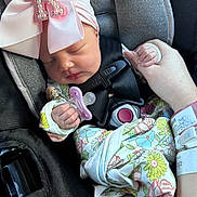 Kinlee joined the competition — help win amazing prizes! newborn, baby, sleeping, infant, car_seat, seatbelt, harness, rhinestone_bow, hair_bow, pacifier, floral_outfit, blanket, hand, portrait, close_up, indoors, vehicle, safe, peaceful, child