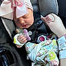 newborn, baby, sleeping, infant, car_seat, seatbelt, harness, rhinestone_bow, hair_bow, pacifier, floral_outfit, blanket, hand, portrait, close_up, indoors, vehicle, safe, peaceful, child
