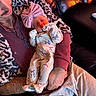 Kinlee joined the competition — help win amazing prizes! newborn, baby, sleeping, infant, child, portrait, bow_headband, floral_outfit, onesie, blanket, adult, parent, arms, cradled, leather_chair, indoor, cozy, family, peaceful, photography