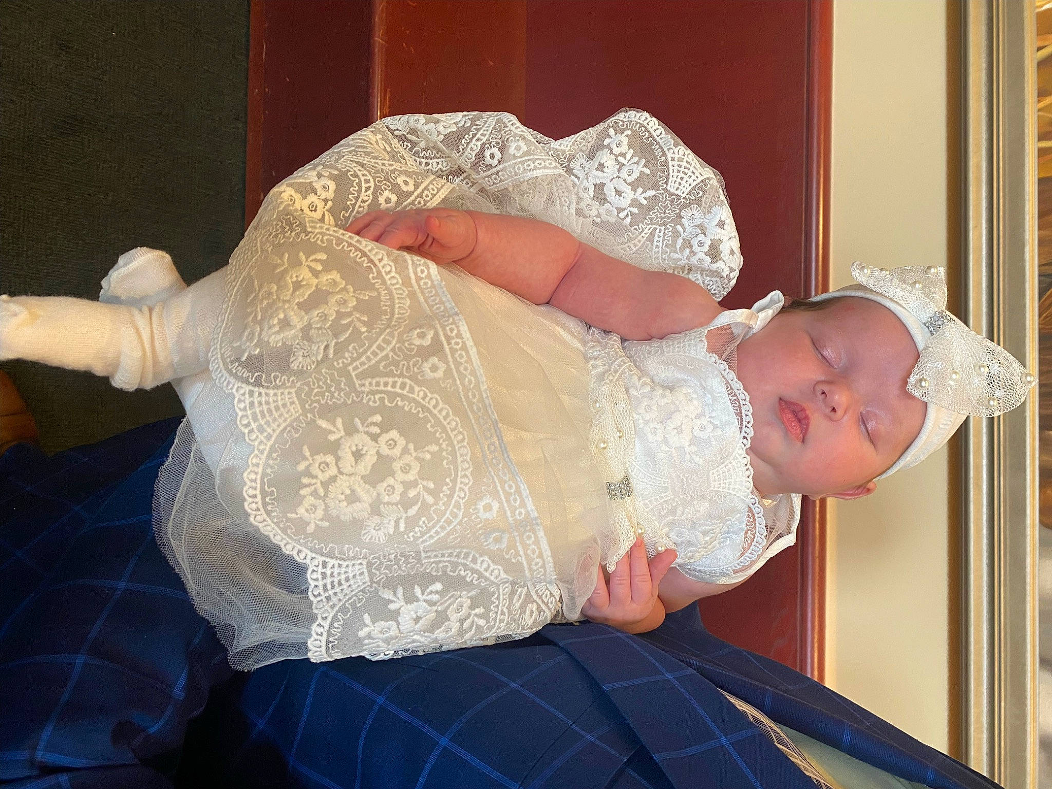 Lilyanna is registered to the contest to win money with this photo: abdomen, baby, baby_toddler_clothing, bridal_accessory, comfort, dress, embellishment, event, fashion_accessory, happy, hat, headgear, headpiece, headwear, human_body, jewellery, leg, pattern, person, textile