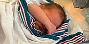Dallas is registered to the contest to win money with this photo: newborn, baby, blanket, hospital, bassinet, sleeping, infant, wrapped, arm, face, peaceful, cozy, hospital_bed, newborn_baby, skin, hair, indoor, closeup, person, quiet