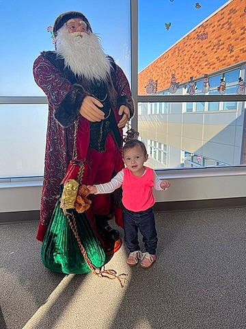 Karma is registered to the contest to win money with this photo: beard, christmas, event, facial_hair, fictional_character, fun, fur, happy, hat, holiday, lap, leisure, moustache, person, plant, santa_claus, sky, toddler, travel, vertebrate