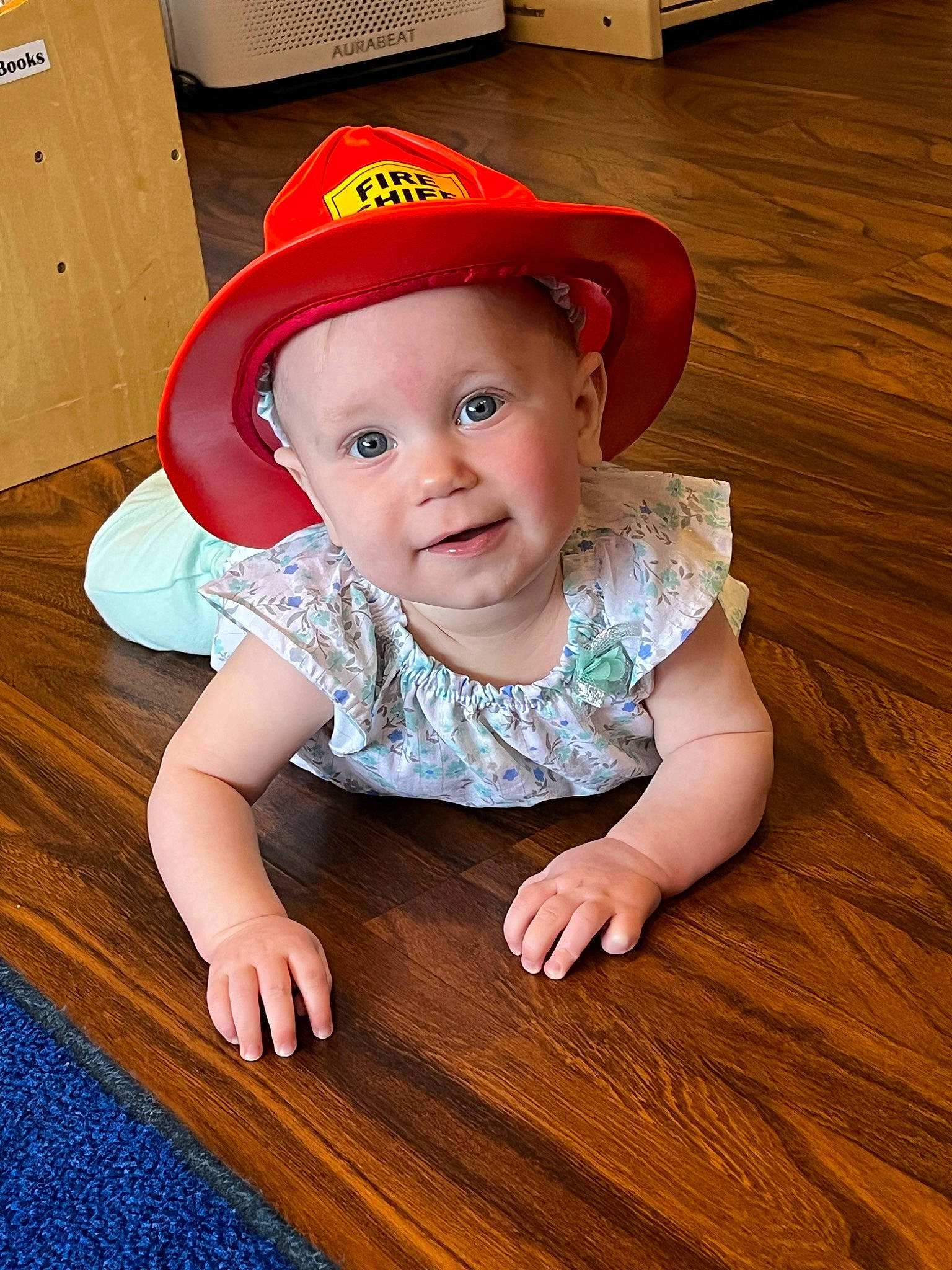 Aubree joined the competition — help win amazing prizes! baby, baby_toddler_clothing, cap, cheek, child, facial_expression, floor, flooring, fun, happy, hardwood, hat, headwear, person, skin, sleeve, smile, toddler, varnish, wood