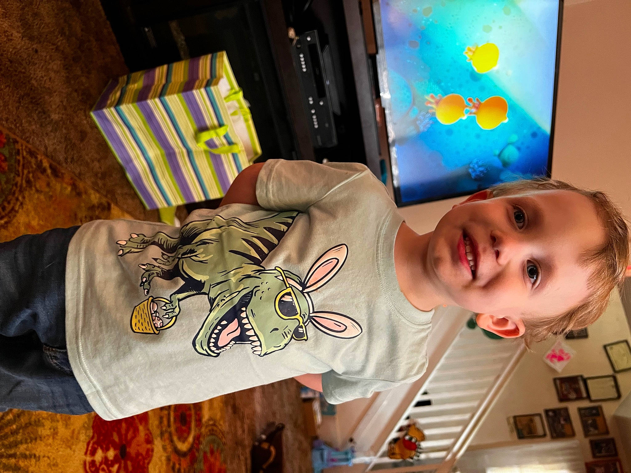 Dominic is registered to the contest to win money with this photo: baby, baby_toddler_clothing, child, clothing, cool, elbow, happy, joy, light, orange, person, photograph, room, sleeve, smile, snapshot, t_shirt, textile, toddler, visual_arts